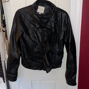 Black leather jacket with ruffle over zipper